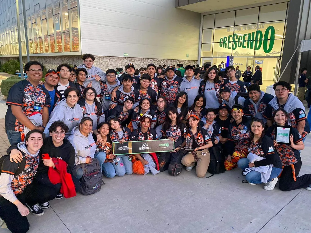Full Innobotics team holding a 6694 banner outside the Regional Hermosillo CRESCENDO venue