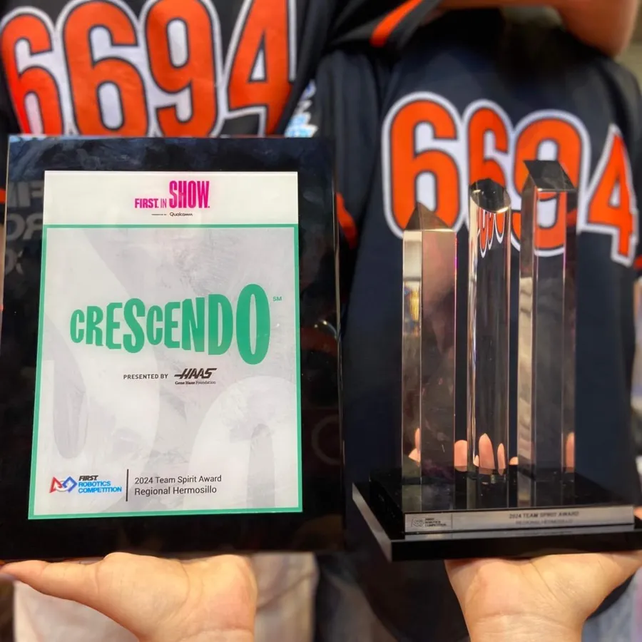 2024 Team Spirit Award plaque and trophy from Regional Hermosillo held in front of 6694 jerseys